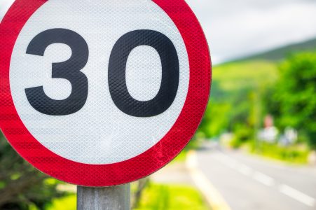 A close up image of a 30mph sign with blurred background