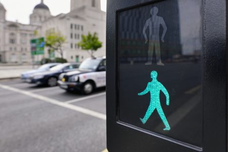 Pedestrian traffic light with a green man walking symbol